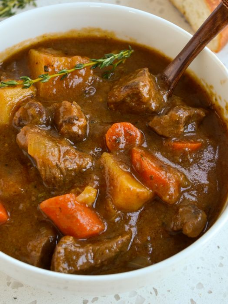 Hearty Irish Stew: A bowl filled with chunky beef, carrots, potatoes, and aromatic herbs in a savory beef gravy.