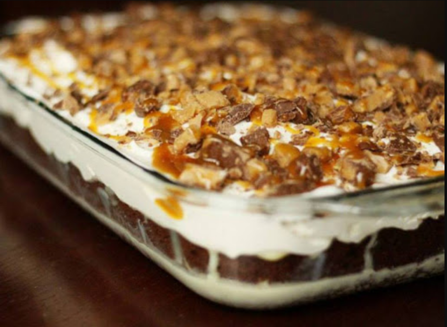 A Slice of Heaven Cake - A luscious chocolate cake topped with sweetened condensed milk, caramel, cool whip, and Snickers bars.