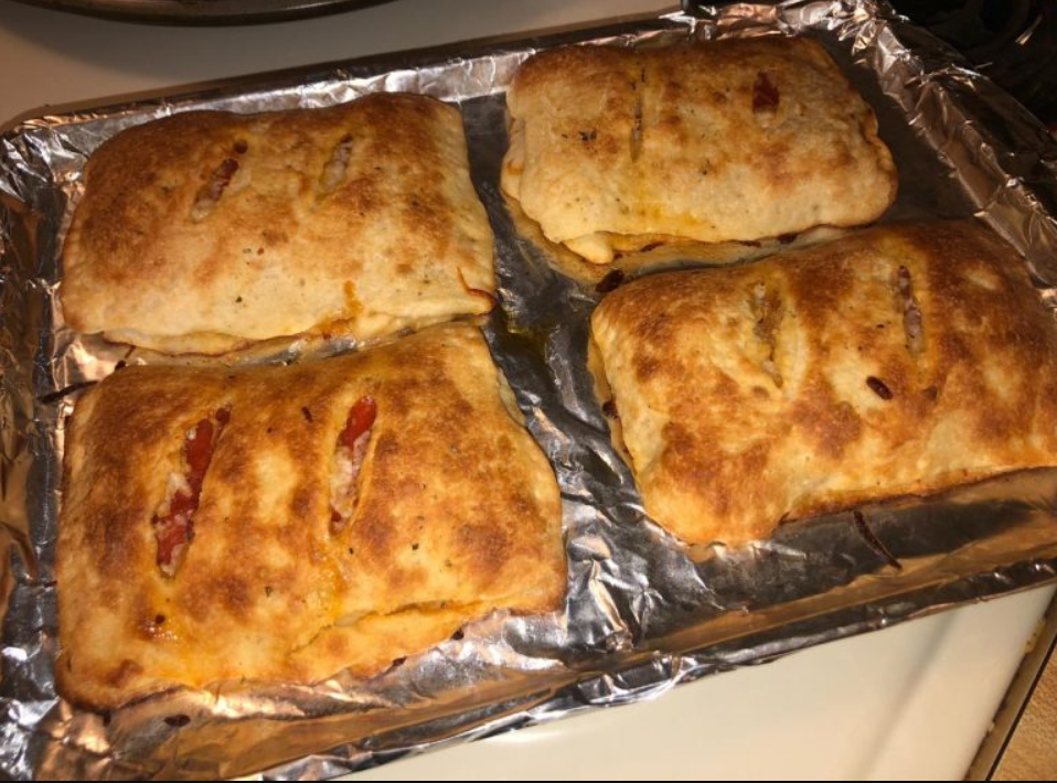 Cheap Pizza Calzones on a baking sheet - a budget-friendly pizza alternative.