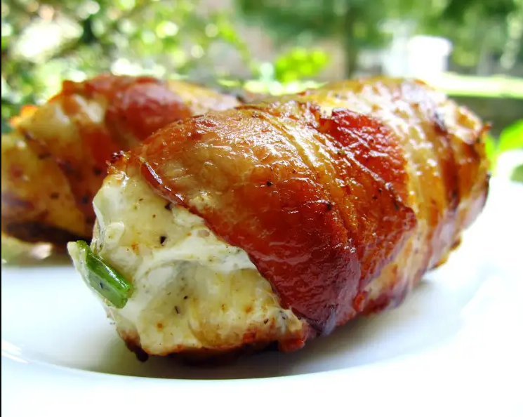 "Bacon-Wrapped Cream Cheese Stuffed Chicken Breast - A succulent dish featuring chicken breasts stuffed with cream cheese, Pepperjack cheese, and green onions, wrapped in crispy bacon."