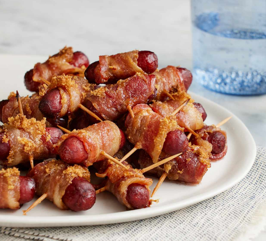 "Bacon-Wrapped Smokies - A delectable appetizer featuring bacon-wrapped little wieners with a caramelized brown sugar topping."