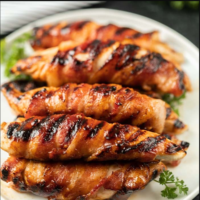 Grilled Bacon-Wrapped Chicken Tenders - Succulent tenders wrapped in crispy bacon, infused with smoky flavor.