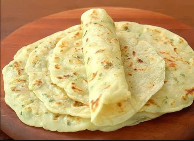 Garlic and Butter Flatbreads stacked on a plate, showcasing their golden-brown perfection.