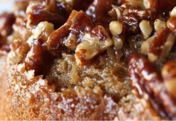 Pecan Upside-Down Bundt Cake displayed on a cake plate, showcasing the caramelized pecan topping.