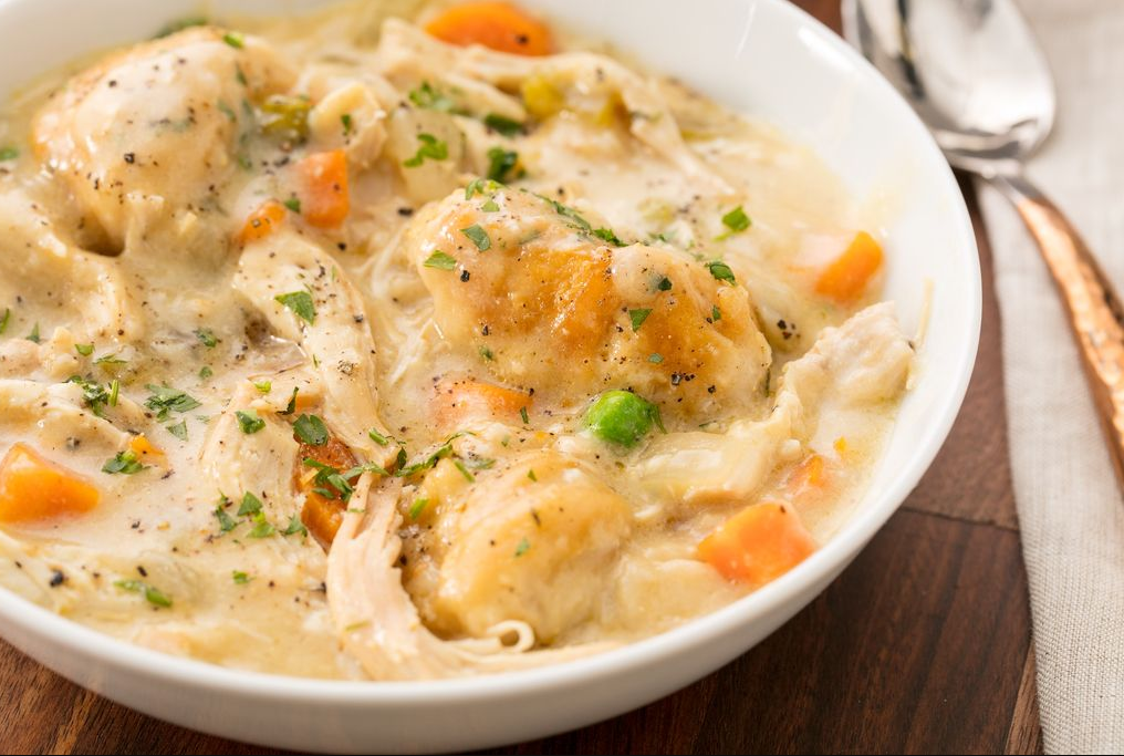 Slow Cooker Chicken and Dumplings served in a bowl, showcasing the tender chicken, flavorful broth, and fluffy dumplings.