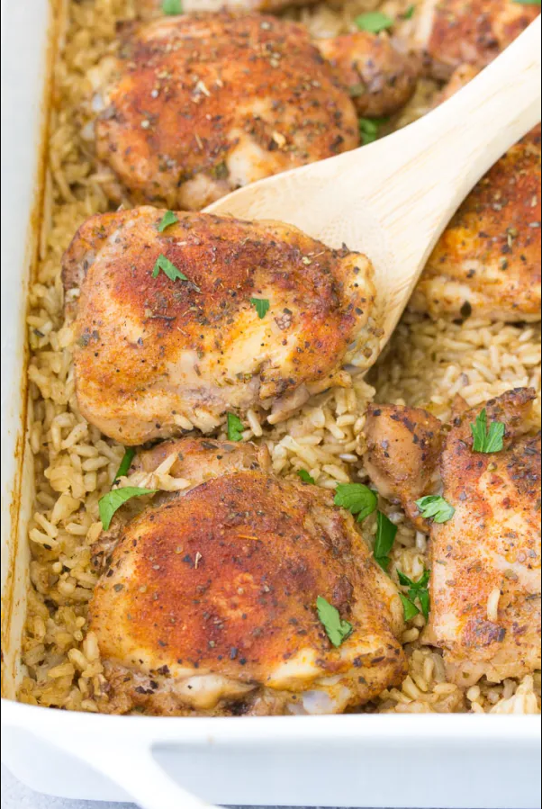 Garlic Parmesan Chicken with fluffy white rice served on a plate, garnished with parsley.