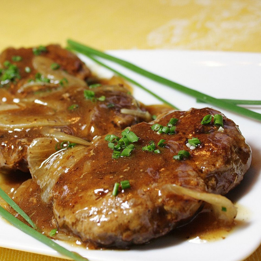 Hamburger Steaks with Onion Gravy served on a plate, showcasing the flavorful patties and rich onion gravy.