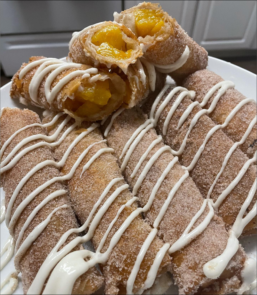 "Peach Cobbler Egg Rolls on a plate, golden and delicious."