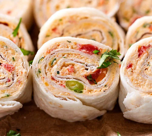 "Mexican Chicken Pinwheels arranged on a platter, showcasing colorful ingredients."