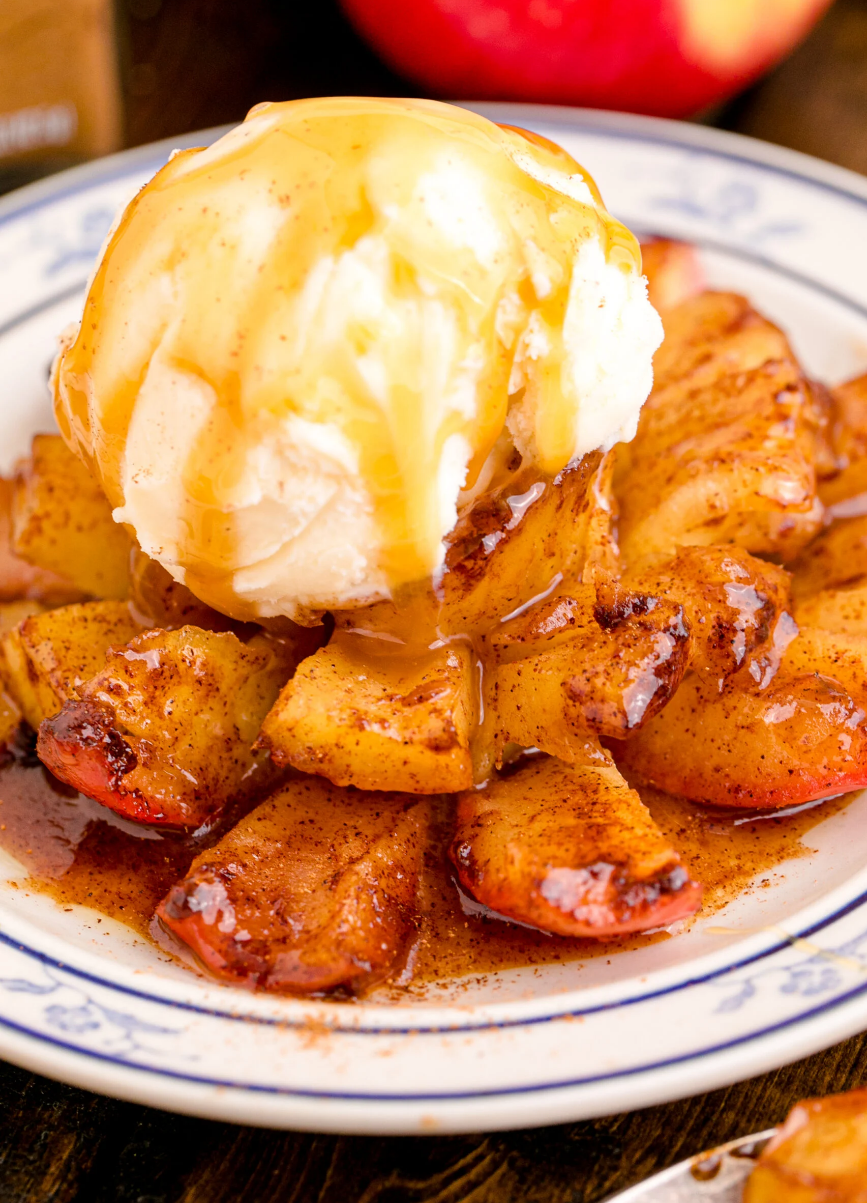 "Oven-Baked Bloomin' Apples topped with vanilla ice cream, cinnamon, and caramel sauce."