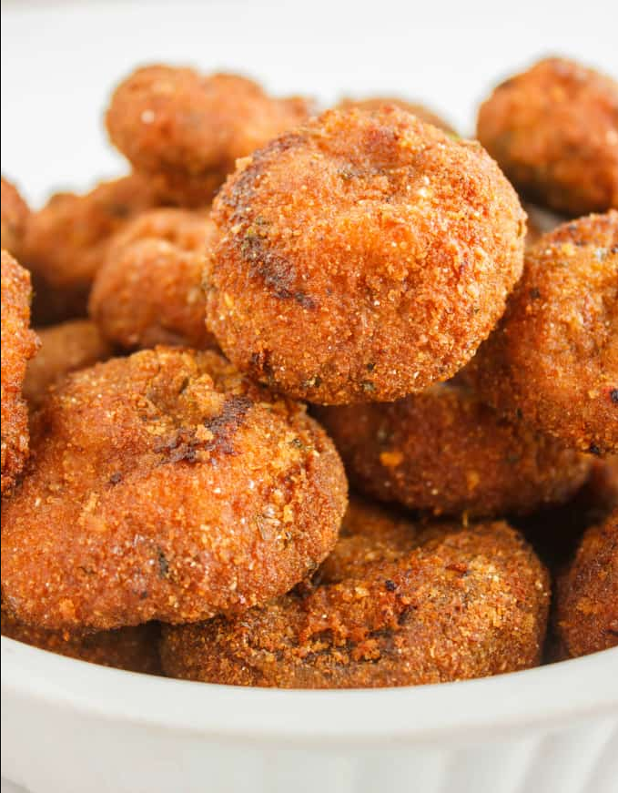 Crispy Fried Mushrooms served on a plate with a side of dipping sauce.