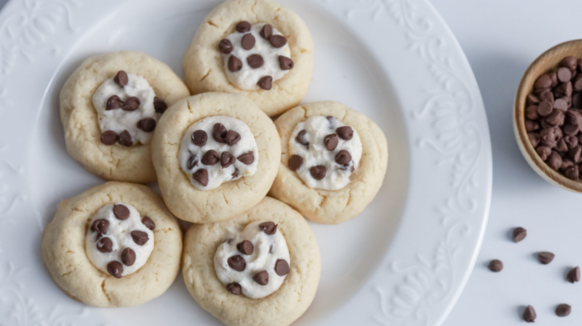 Decadent Cannoli Cookies with chocolate chips and pistachios, lightly dusted with powdered sugar.