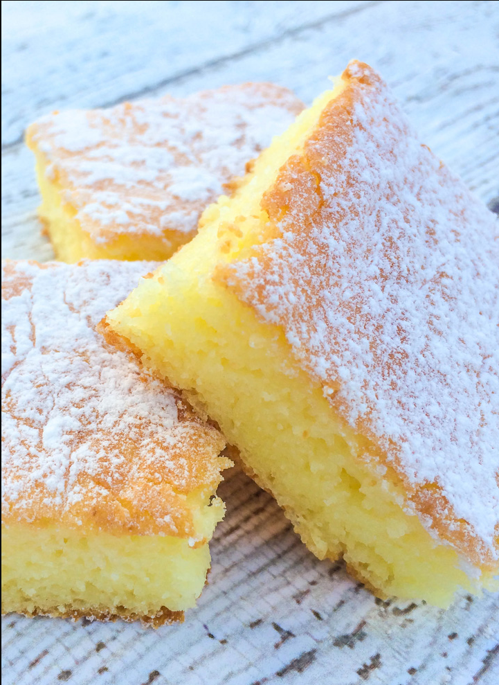 Two-Ingredient Lemon Bars displayed on a white plate with a sprinkle of powdered sugar.