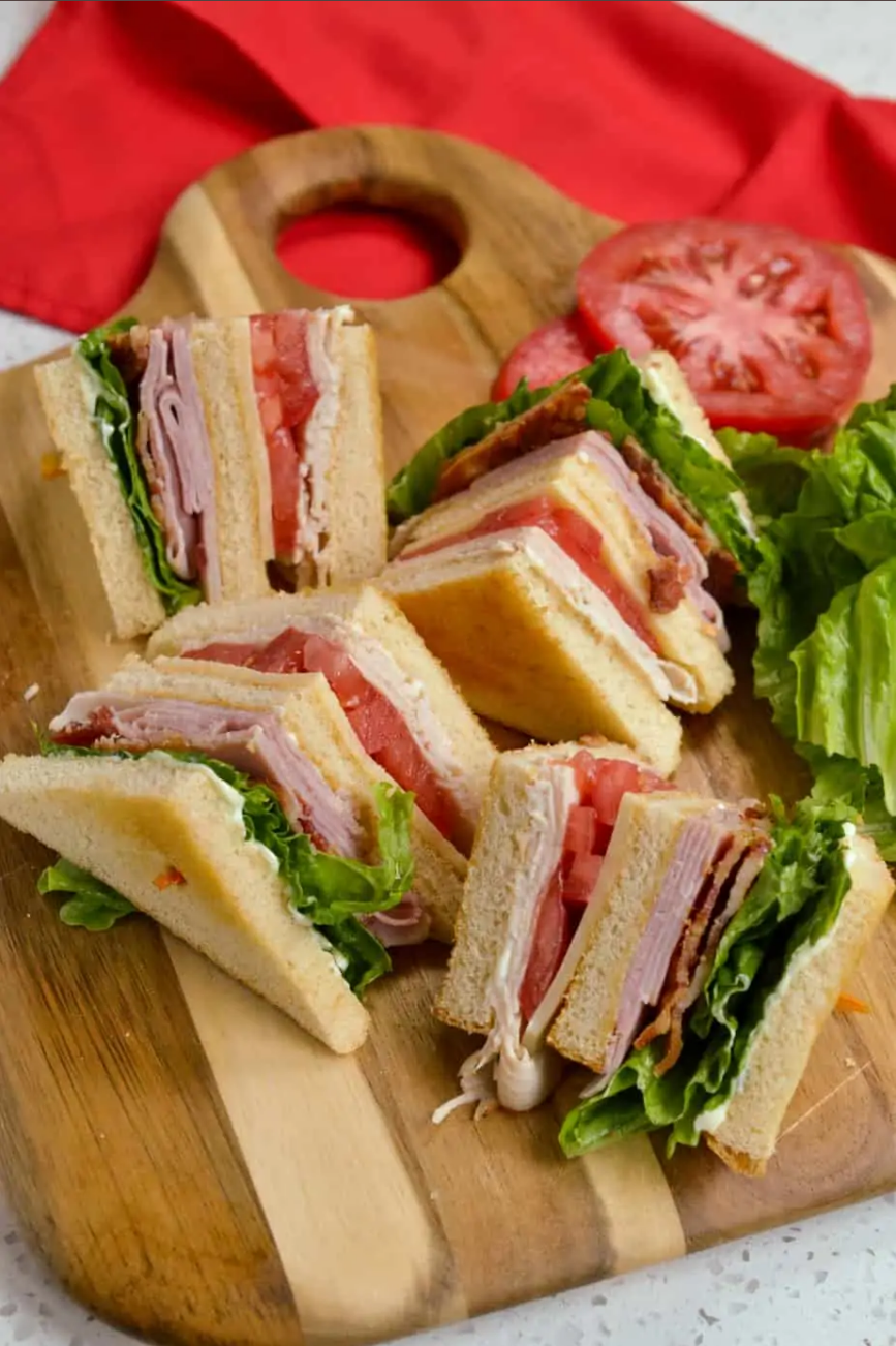 Classic Club Sandwich - A stacked masterpiece of toasted bread, deli turkey, ham, bacon, and fresh lettuce and tomato.