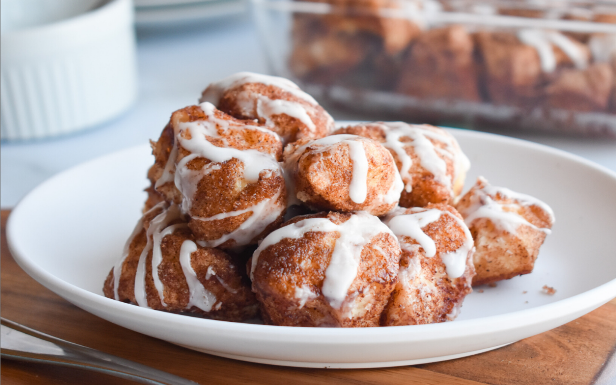 Cinnamon Sugar Biscuit Bites - Golden brown biscuit nuggets coated in a cinnamon-sugar mixture, drizzled with sweet vanilla icing.