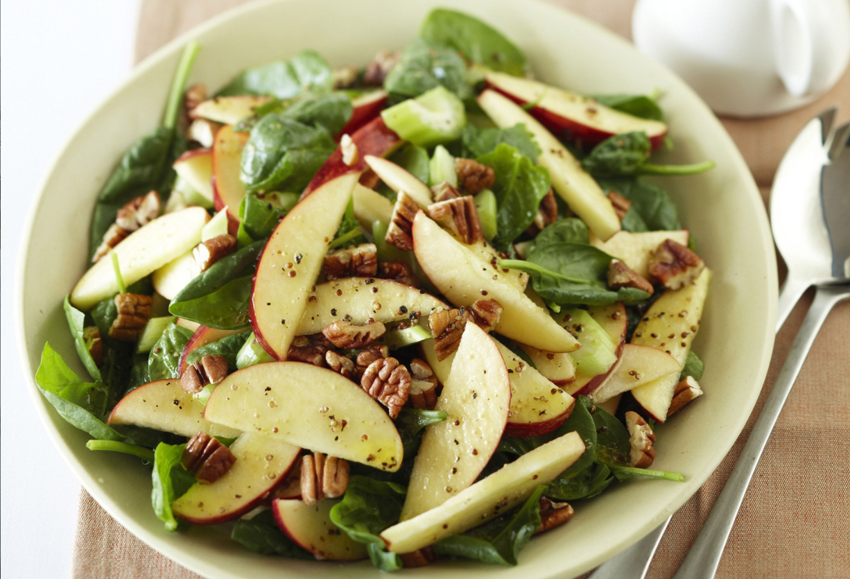 Spinach Apple Salad - A vibrant mix of fresh baby spinach, sliced apples, walnuts, feta cheese, and dried cranberries, tossed in a balsamic honey dressing.