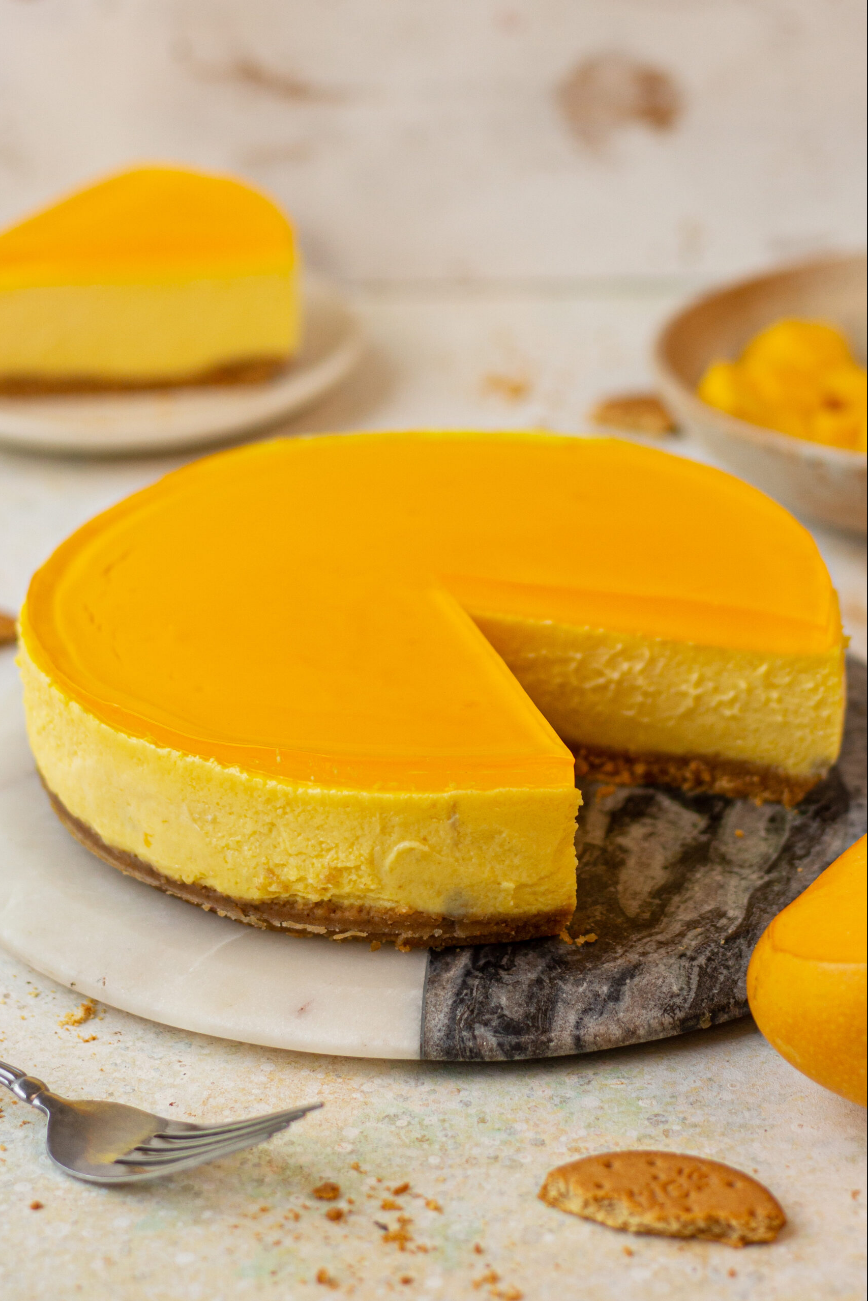 Mango Cheesecake - A visual feast featuring a creamy cheesecake adorned with layers of mango puree. A delectable treat for dessert lovers.