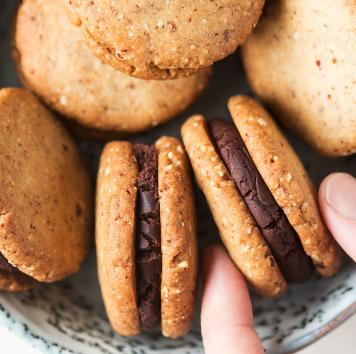 Chocolate Crust Biscuits - Buttery and coconut-infused biscuits with a hint of ginger, sandwiched together with smooth apricot jam, and dipped in rich, melted chocolate.