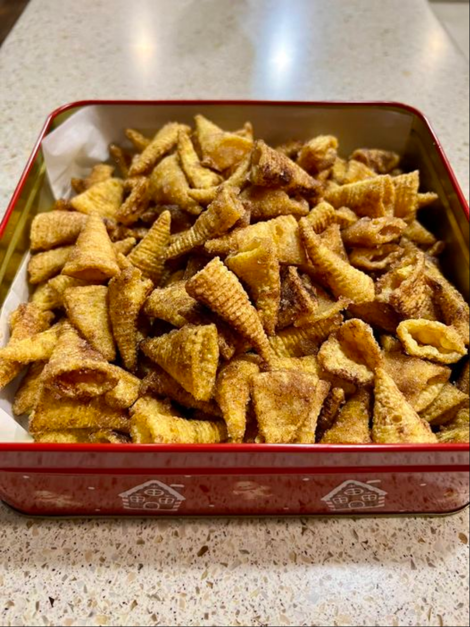 Cinnamon Bugles - A delightful mix of Bugles coated with a sweet cinnamon glaze, served in a bowl for snacking.