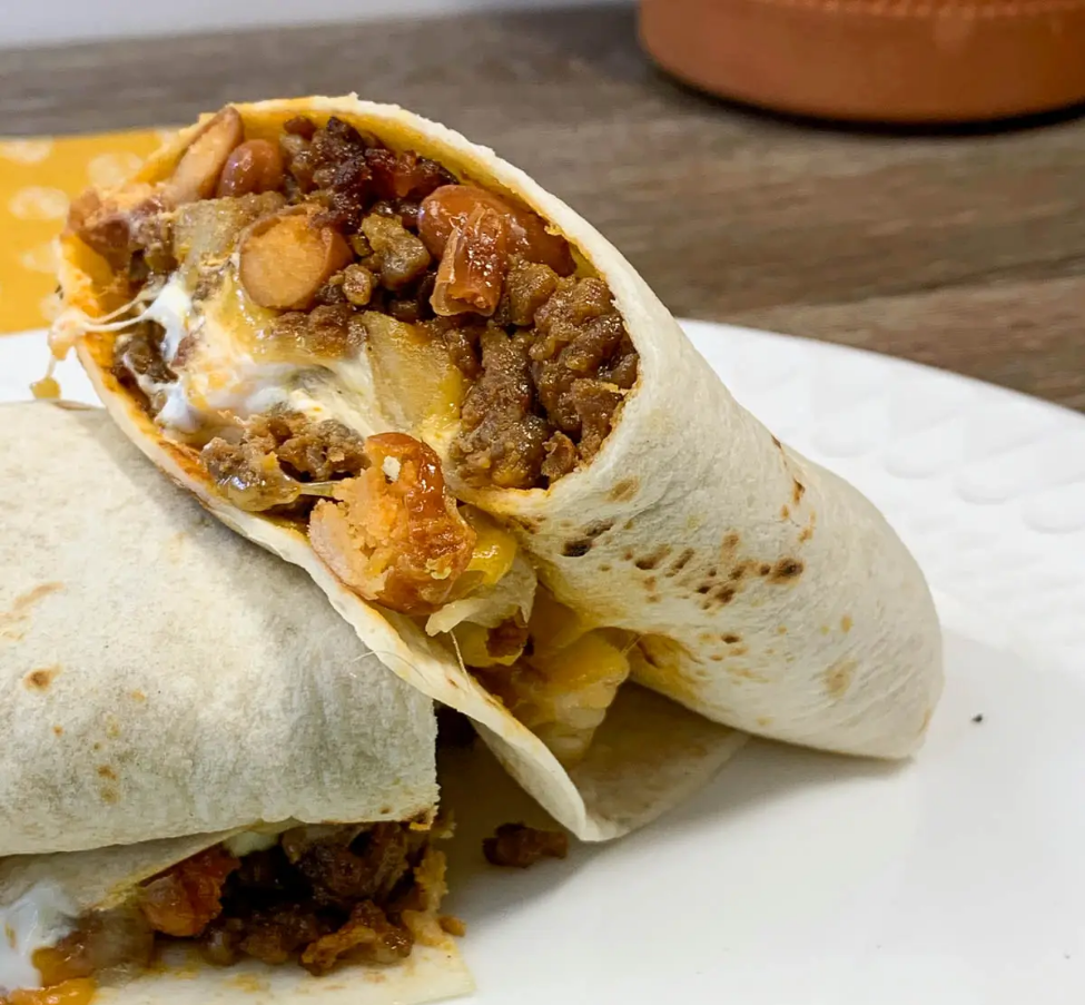 Cheesy Potato Burritos - A delectable combination of seasoned ground beef, crispy tater tots, and melted cheese wrapped in a warm tortilla.