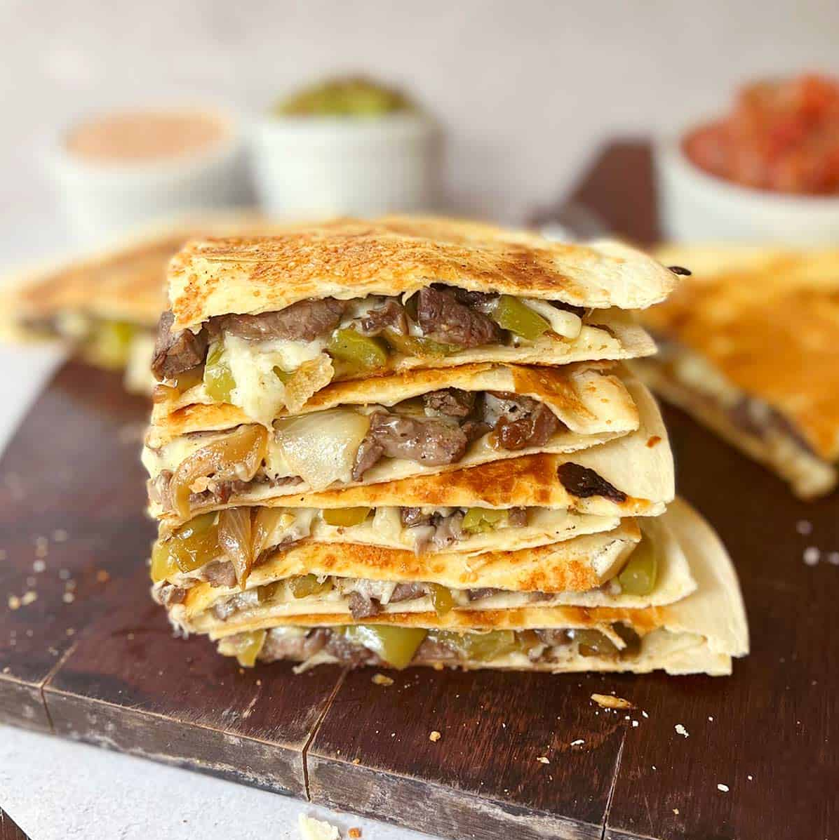 Loaded Steak Quesadillas with seasoned sirloin, veggies, and melted cheese – a delicious treat for your taste buds.