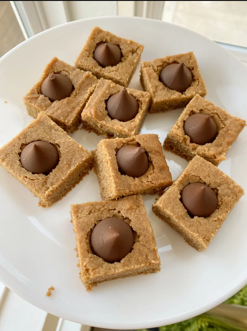 Peanut Butter Blossom Bars – A batch of freshly baked bars with a Hershey's Kiss in the center, a delightful peanut butter and chocolate treat.