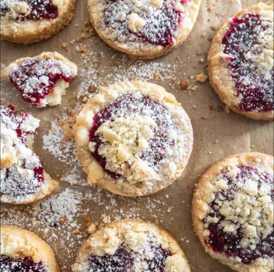 Raspberry Crumble Cookies – A jumbo muffin tin filled with buttery crumble cookies, each holding a sweet center of seedless raspberry jam.