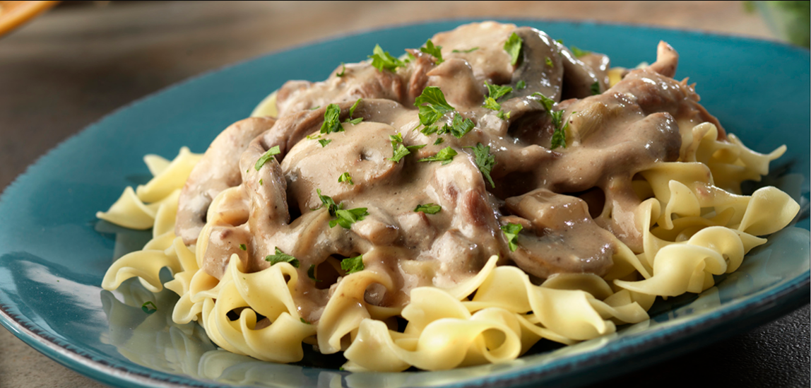 Creamy Beef Noodle Delight – A steaming pot of stir-fry beef, creamy mushroom soup, dumpling egg noodles, and flavorful spices, creating a one-pot wonder.