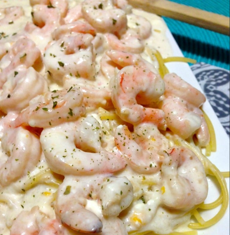 Cheesy Garlic Shrimp Alfredo - A delectable blend of shrimp, creamy Alfredo sauce, and cheese over fettuccine noodles.